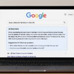 Laptop displaying Google AI Mode interface with AI-generated search summary and follow-up suggestions.