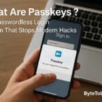A smartphone showing a passkey passwordless login prompt in front of a laptop, illustrating secure authentication technology.